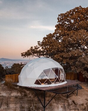 Experience the unique geodesic dome tent, offering panoramic views of the city from its elevated hillside location.