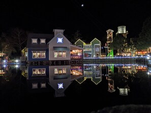 A waterfront property with multiple buildings, a dock, and a tower with signage. - "Hidden Gem" - Golf Cart Fun with 5-Star Hosts! (Miramar Beach)
