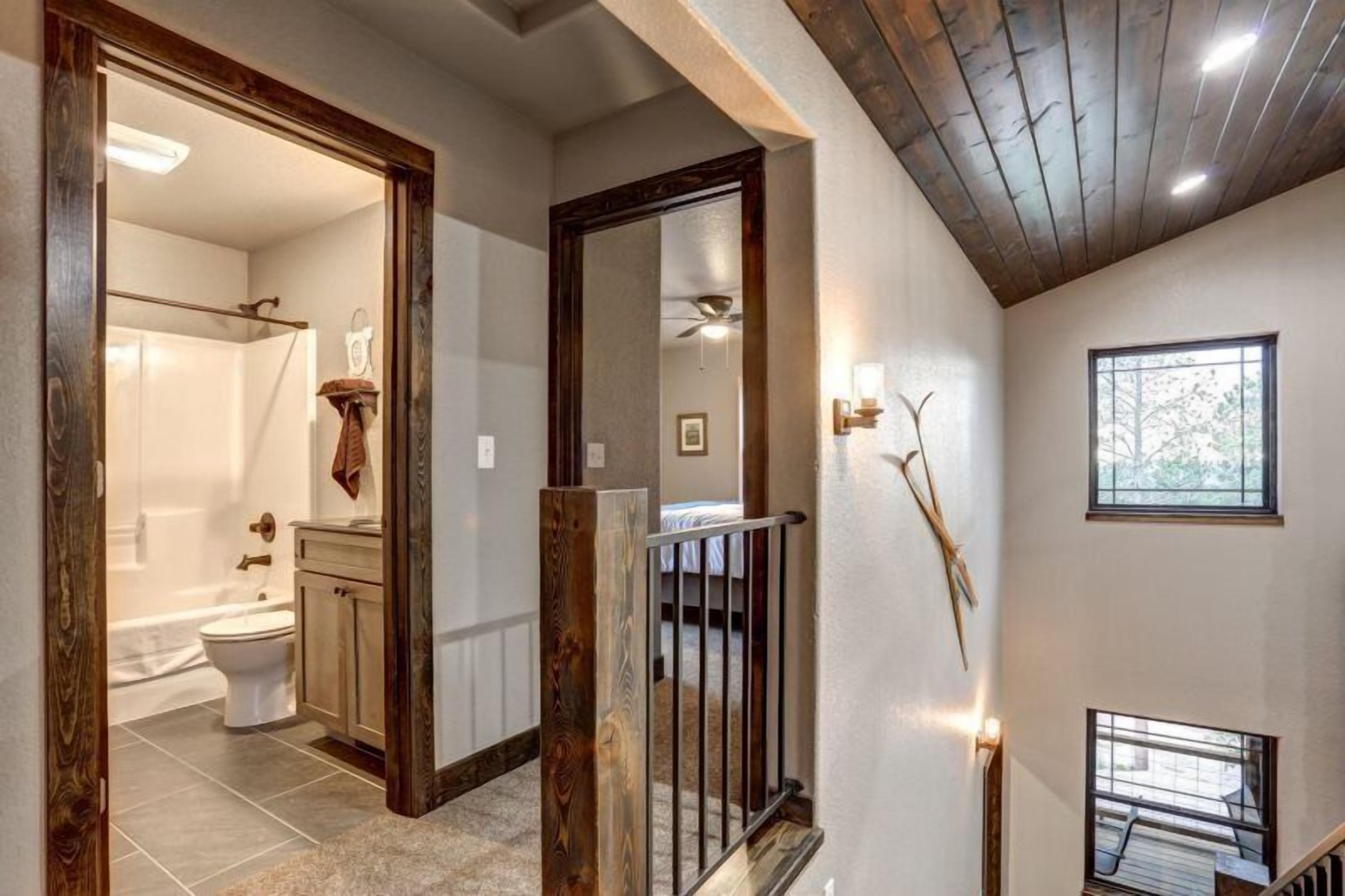 A modern bathroom with a shower, toilet, and vanity.