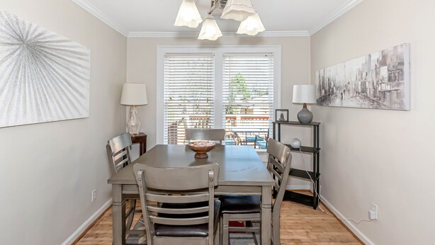 A dining area with a table, chairs, a chandelier, and artwork on the walls. - Classic style home with a laid-back feel and required amenities for comfort.  (vestavia hills)