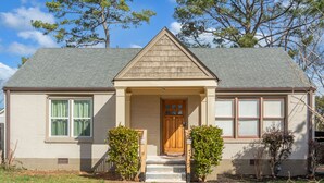 A single-story house with a gabled roof, a front door, and a small porch. - Classic style home with a laid-back feel and required amenities for comfort.  (vestavia hills)