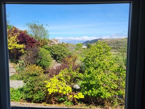Enjoy a serene view of the lush garden and rolling hills from the comfort of your room.