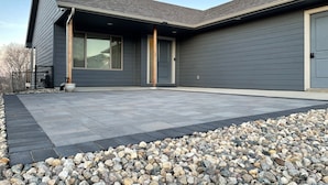 A modern house with a stone patio and a gravel border. - Cozy 4King bed+3Bath near Downtown&Airport open concept Scenic backyard view (Sioux Falls)