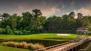 A wooden bridge leading to a gazebo over a pond on a golf course. - Modern Beachhouse, Pool, 73 Steps to Beach, Deck Fully Loaded, Arcade (Nags Head)