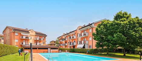 En boligbygning med swimmingpool og et skilt, der angiver 'SMART WORKING'.