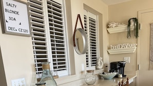 A kitchen with a white countertop, a coffee maker, and a dish rack. - Perfectly Curated 30A Escape - Steps to Beach & Gulf Place (Santa Rosa Beach)