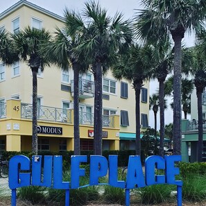 A sign for GULF PLACE with a yellow building in the background. - You Want 30A, Stay on 30A! Salty Blonde @ Gulf Place steps from  deeded beach (Santa Rosa Beach)