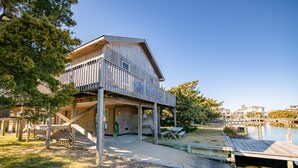 A wooden cabin with a balcony, a dock, and a grassy area with picnic tables. - Waterfront, Dog friendly, & private boat ramp (Frisco)
