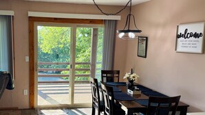 A dining area with a table, chairs, and a view of a balcony. - Relax and recharge at The Spot (Fall River)