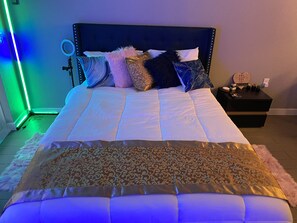 Cozy retreat with a large bed, pillows, and a convenient table with WiFi access.