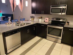 Enjoy cooking in this well-equipped kitchen with an oven, stainless steel appliances, and ample workspace.