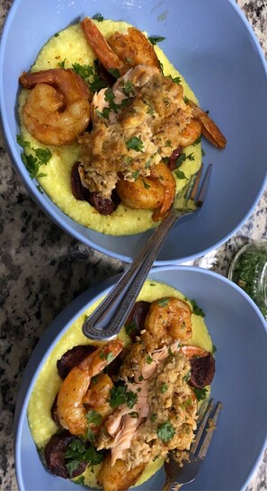 Savor a delicious meal at this elegant dining table, set with fine silverware and a beautifully presented seafood dish.