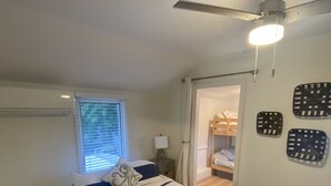 A bedroom with a bed, a ceiling fan, a window with blinds, and a door leading to another room. - Sea Breezy Vacation House, Unit 2 - 5 min WALK to beach!! (Old Orchard Beach)