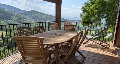 Sunlight and quiet. Mountains, thermal baths and pool in summer. Panoramic view.