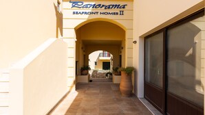 A corridor with a sign for 'Panorama Seafront Homes II'. - 5m walk to sandy beach, restaurants & shops! (Rethymno)