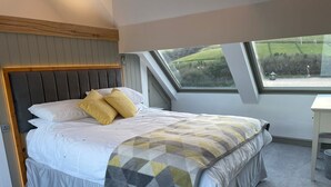 A bedroom with a bed, a window, and a view of the outdoors. - Traditional cottage with stunning views and walks on the doorstep. (Holmbridge)