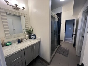 Combined shower/bathtub, towels, soap, toilet paper