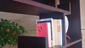 A bookshelf with books and a potted plant.