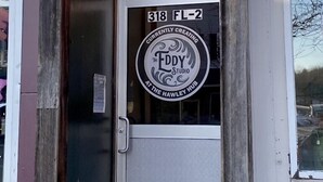 A storefront with a sign reading "The Eddy Studio" and "Currently Creating at The Hawley Hub." - Historic Downtown Hawley Loft (Hawley)
