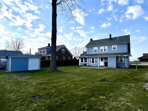 A two-story house with a large front yard and a garage.