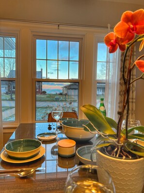 A dining table with various dishes and a potted plant.