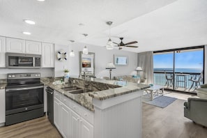 Enjoy ocean views from the balcony, relax in the living area with a sofa and dining table, and cook in the kitchen with a microwave and oven.