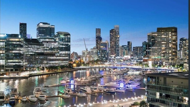 A waterfront marina with modern buildings and boats docked.