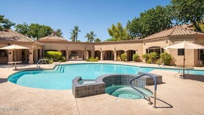 A swimming pool with a hot tub, surrounded by covered seating areas and palm trees. - 2 King Suites with Heated Pools/Spas/Gym in great North Scottsdale Location! (Scottsdale)