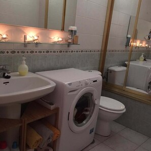 Bathtub, hair dryer, towels, soap