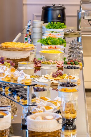 A buffet with various food items including salads, cheeses, and desserts. - Hotel Residence Plaza (Tbilisi)