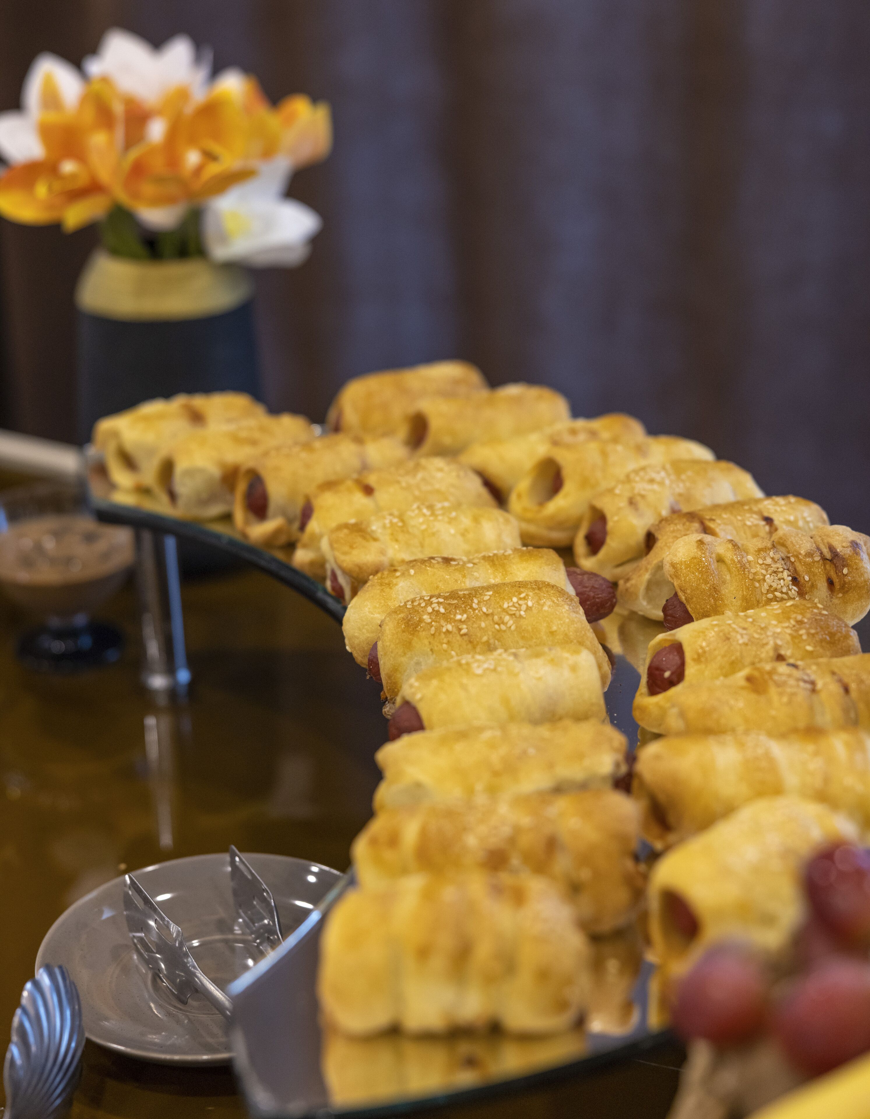 A table with pastries and utensils, suggesting a dining setting.