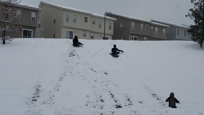 A residential area with a snow-covered slope and apartment buildings in the background. - DC  Townhouse  close to Capitol (Washington)