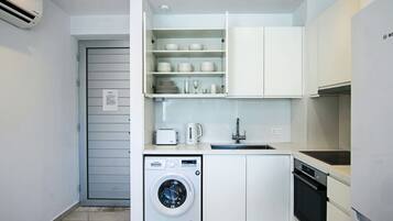 Executive Apartment | Private kitchen | Fridge, electric kettle, high chair, dining tables