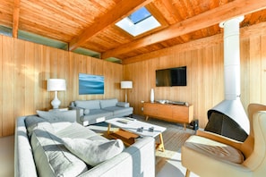 A cozy living room with a sofa, coffee table, and a fireplace.