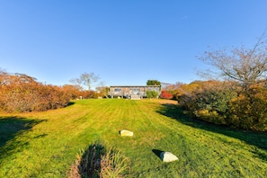 A modern house with a well-maintained lawn and a clear view of the front yard.