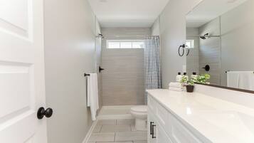 Combined shower/bathtub, hair dryer, towels, soap