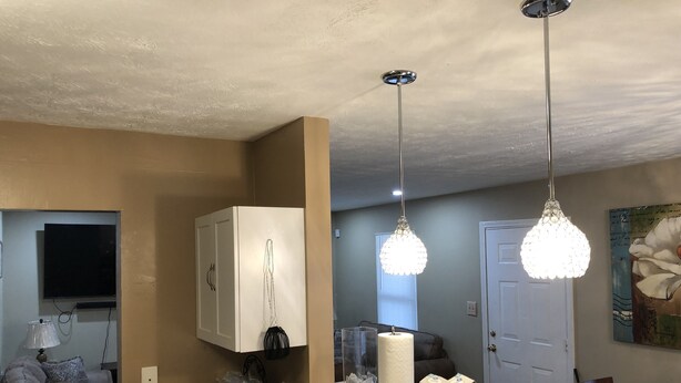 A kitchen with a white countertop, a white cabinet, and a hanging light fixture. - 1220 Hartford Avenue <br> Previous 4 star owner , Airbnb<br>Happy New Year to All (Atlanta)