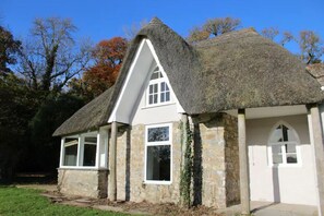A thatched-roof cottage with stone walls and white-framed windows. - Quintessential, secluded South Devon cottage (Plymouth, Devon)