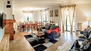 A spacious living room with a dining area, a sofa, and a TV mounted on the wall. - Lovely home in Gizycko with WiFi (Gizycko)