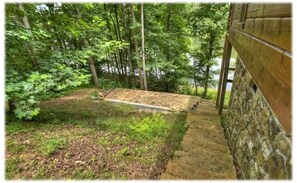 Relax in a serene natural setting surrounded by lush foliage and a tranquil water feature.