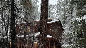 A snow-covered landscape with a building surrounded by trees. - Relaxing 3 bedroom retreat in the pines , come relax in tranquility,<br>  (Pinetop)