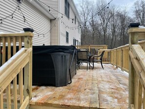 A covered outdoor deck with a table and chairs, a covered trash bin, and a wooden railing. - 4Bedrooms+BonusRoom Firepit Hottub Linens   Golf Casino Camelback SKI Mts! (Cresco)