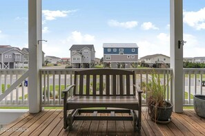 Guests can enjoy a quiet moment on the deck, surrounded by a charming white picket fence.