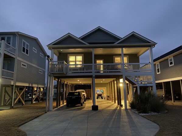 Stunning two-story residence with a covered front porch and balcony.