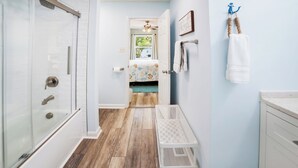 A bathroom with a shower, toilet, and sink. - The Inkwell ~ An Oak Island Gem (Oak Island)