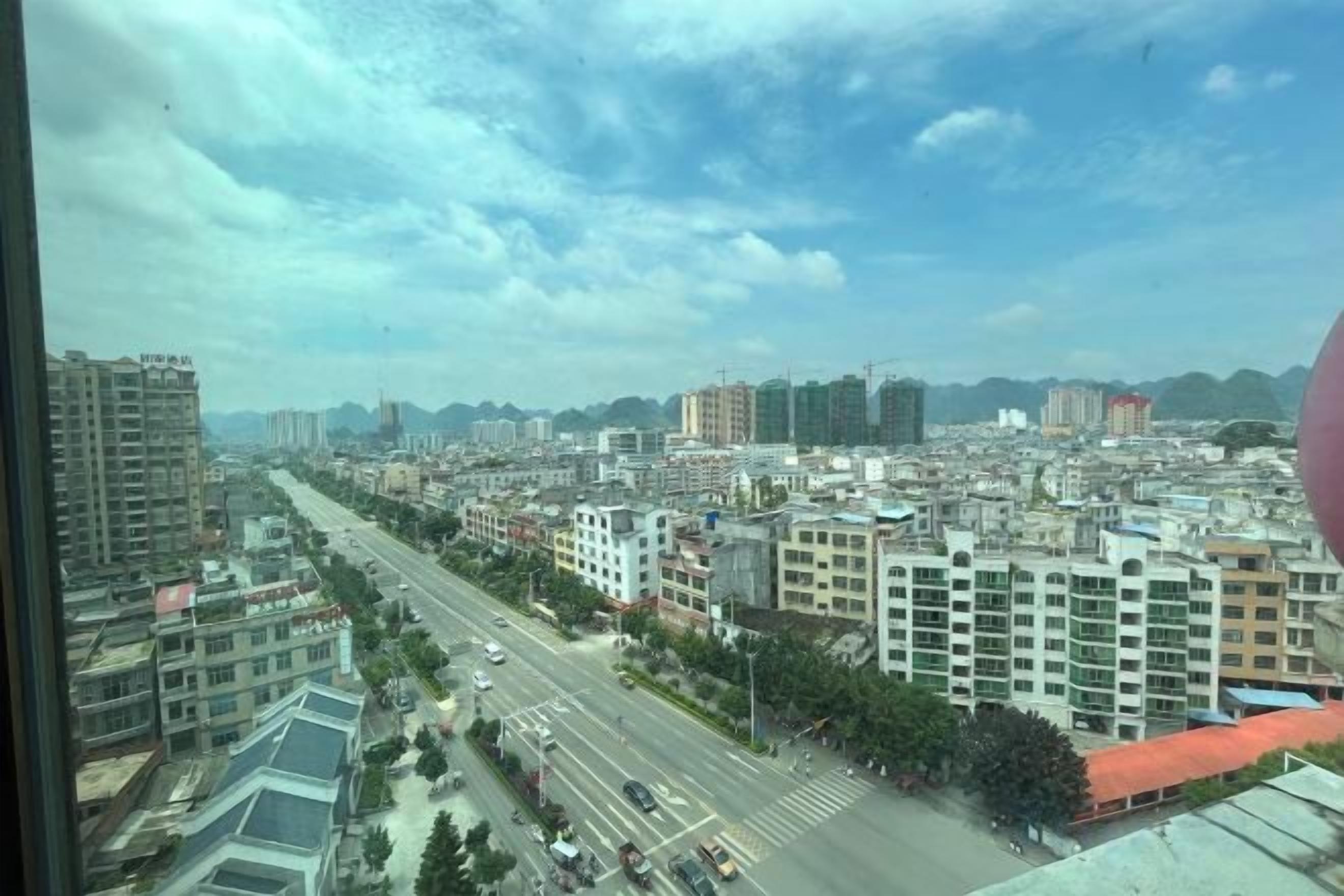A cityscape with buildings, roads, and a clear sky.