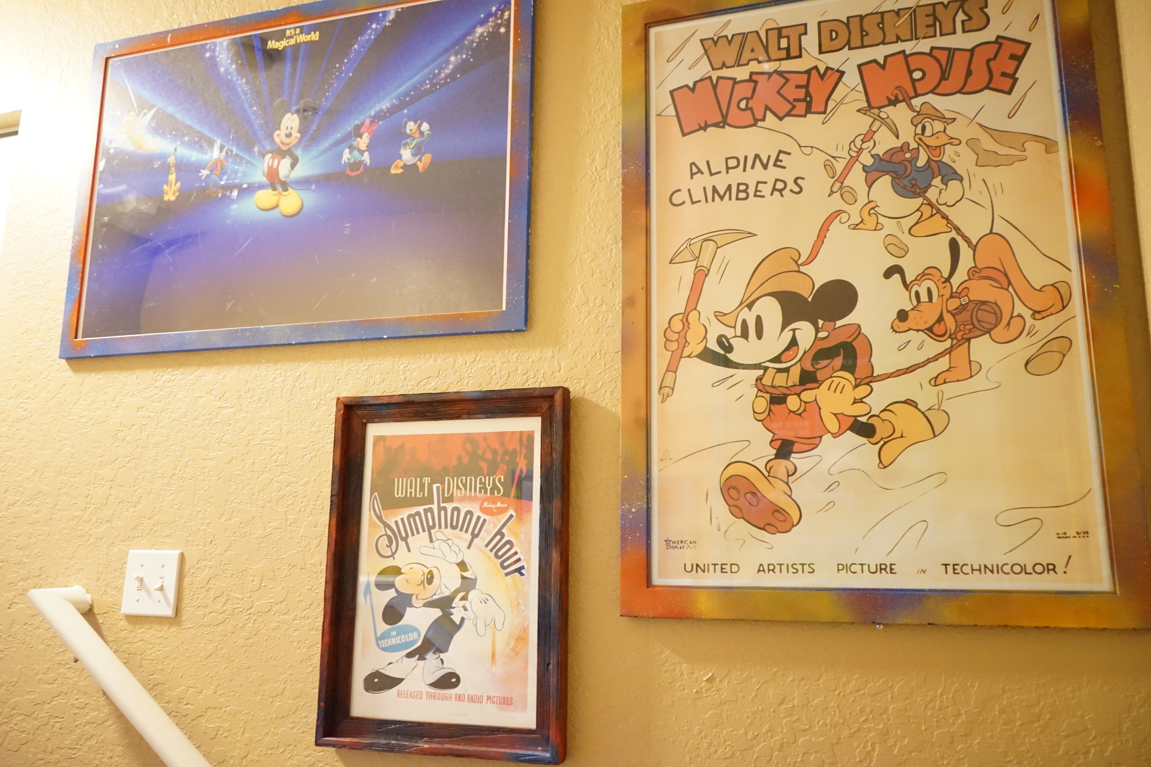 Three framed posters on a wall.