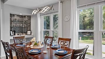 Enjoy meals with family and friends at this spacious dining area, featuring a large table and comfortable seating for six.