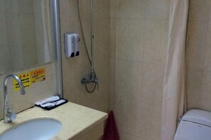 A bathroom with a sink, mirror, shower, and toilet. - Fuxin Hotel (Xuancheng)