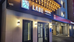The exterior of the Labe Hotel with a modern facade, illuminated signage, and a visible entrance. - LABE Hotel (Jeonju)